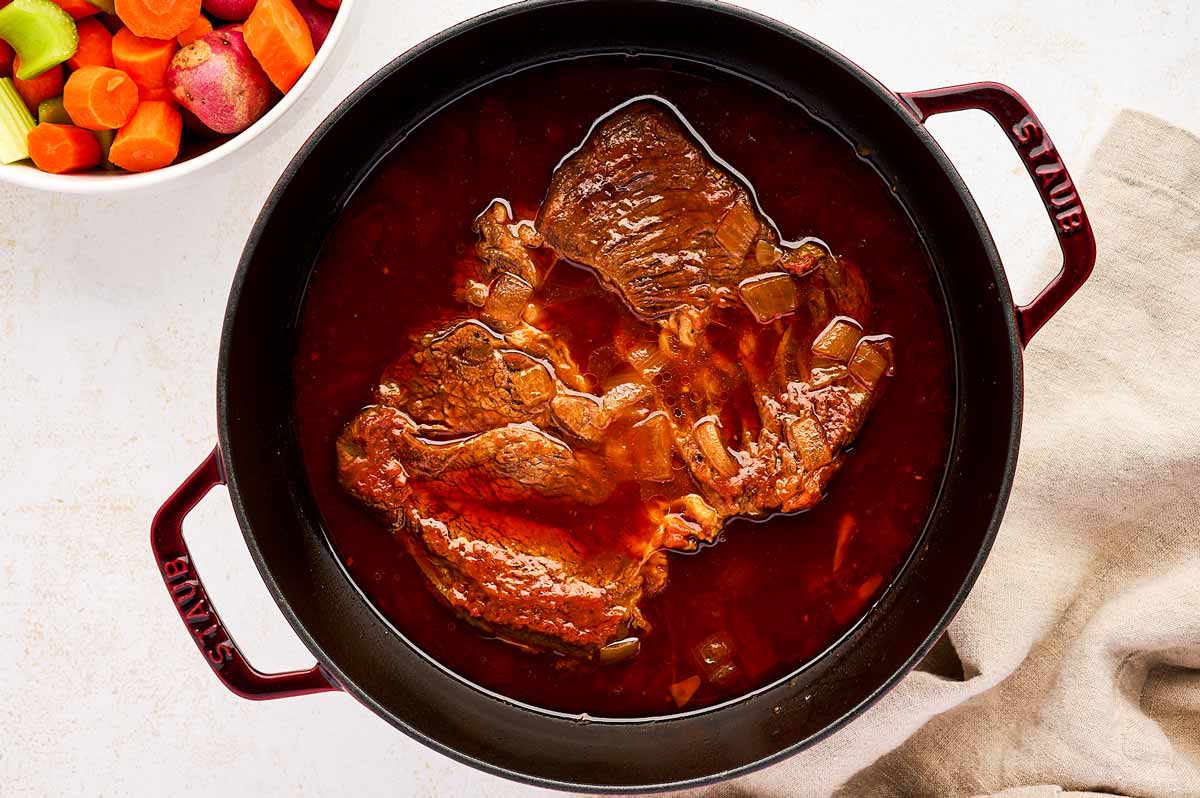 Slow cooking a chuck roast in a cast iron braiser.