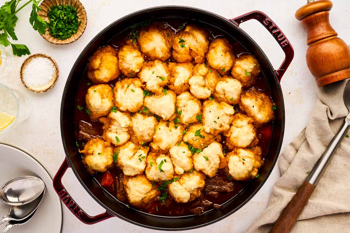 Serving beef and dumplings from a cast iron braiser.