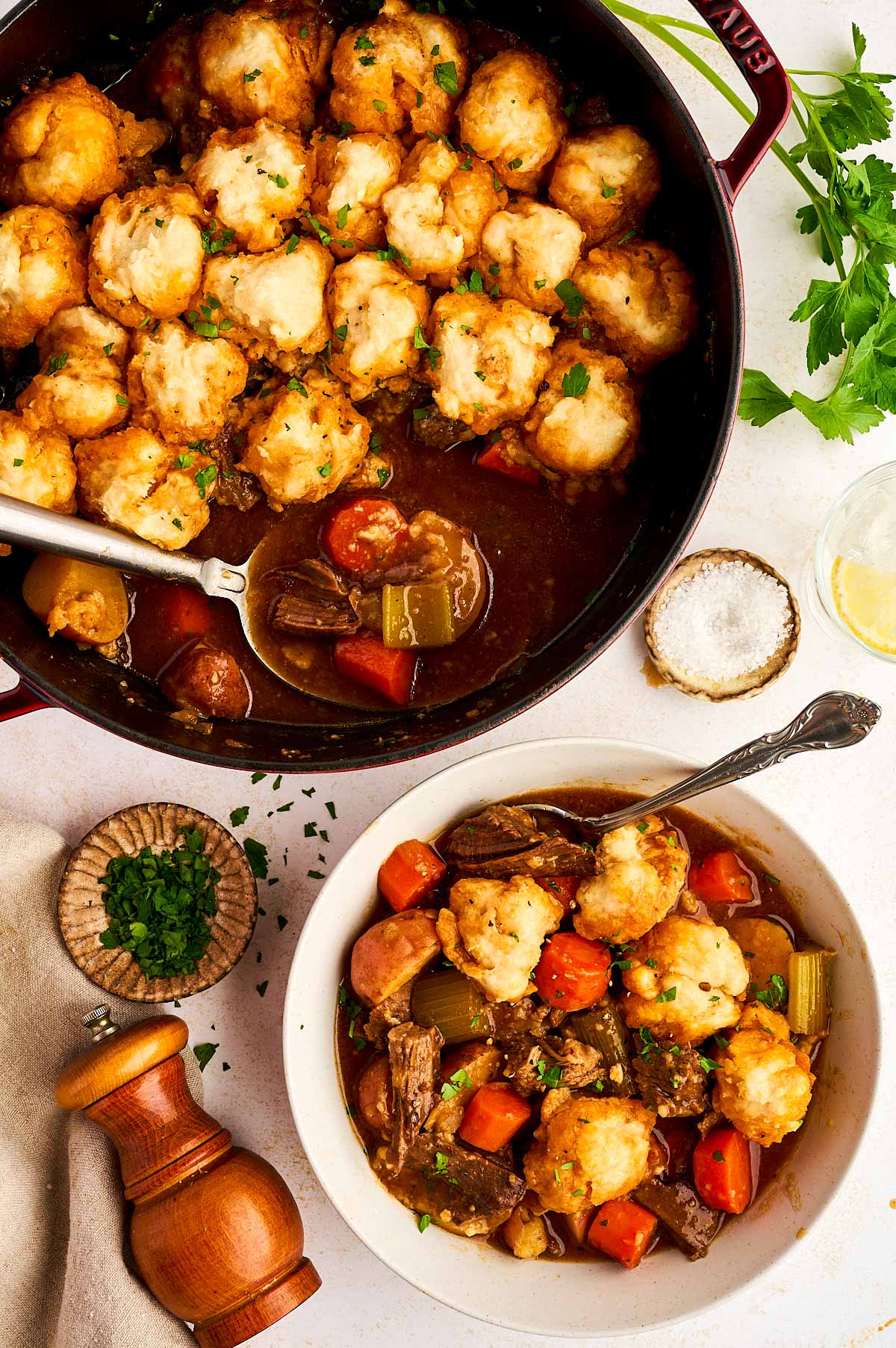 Serving beef and dumplings from a pot.