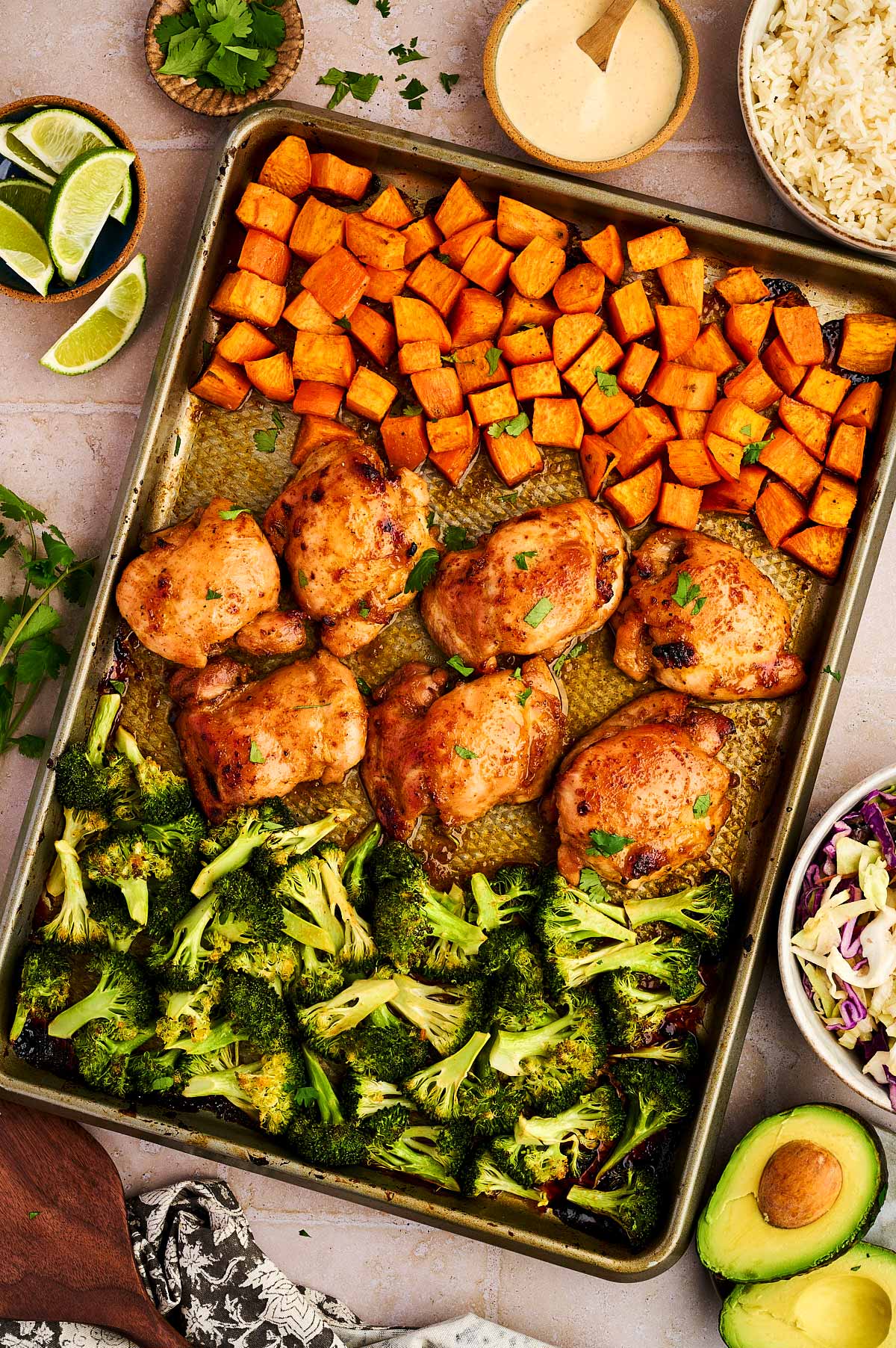 Spicey honey chicken sheet pan dinner with garnishes.