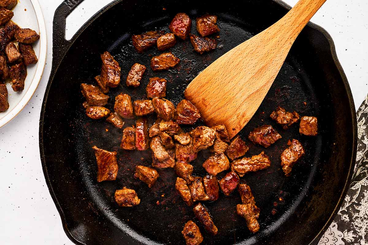 Searing steak pieces for tacos.
