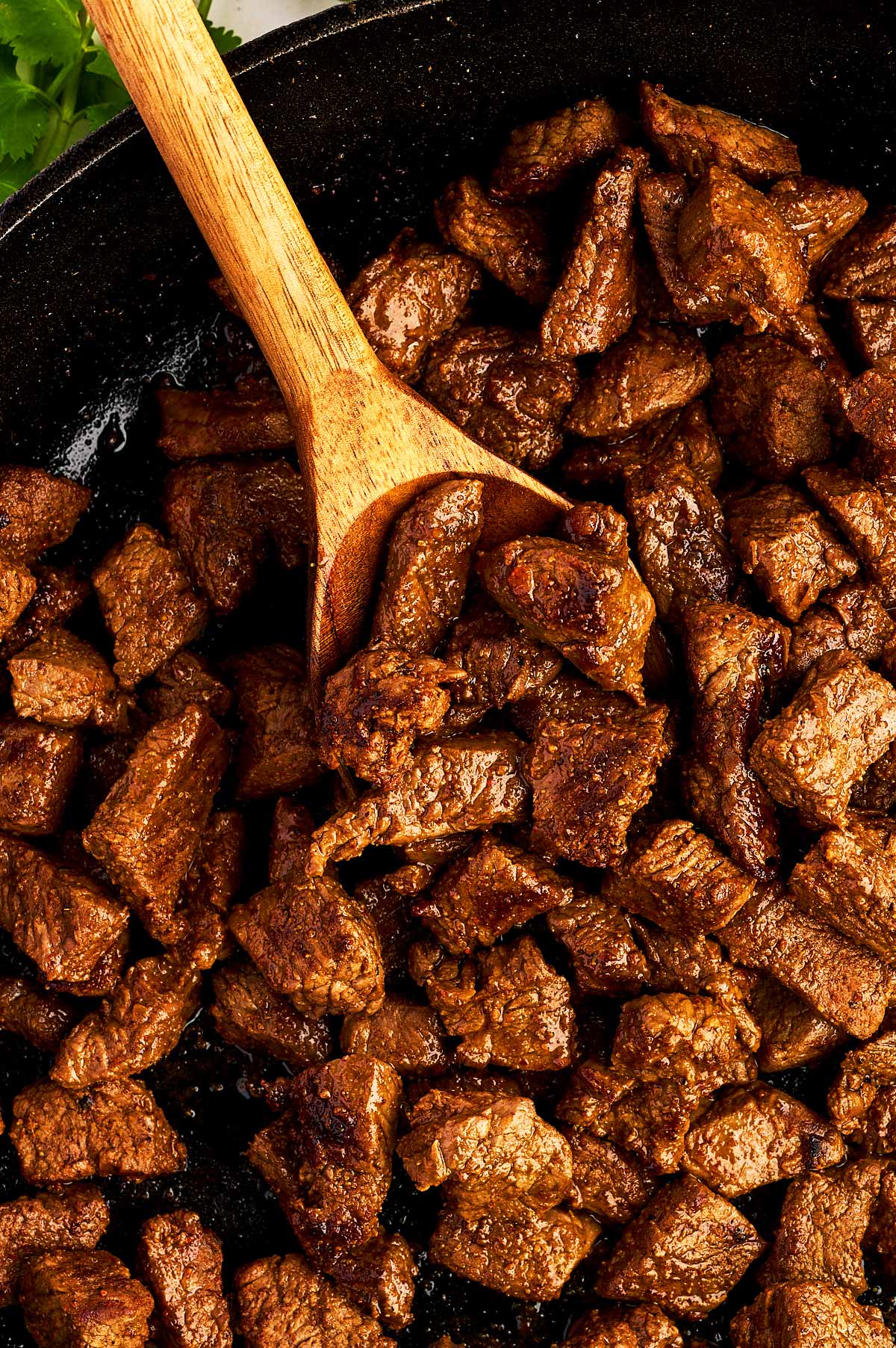 Seared steak for tacos in skillet.