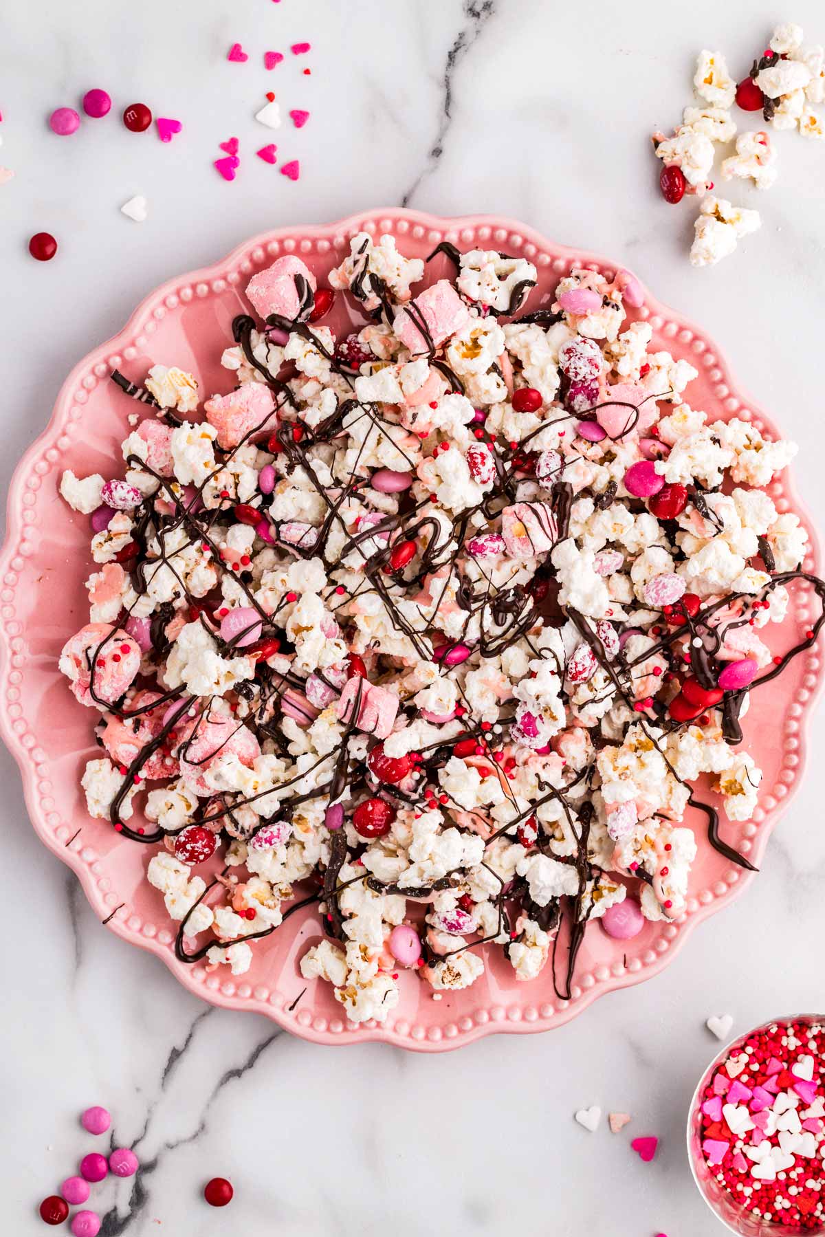 Pink plate with Valentine's Day popcorn.