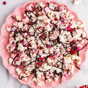 Pink plate with Valentine's Day popcorn.