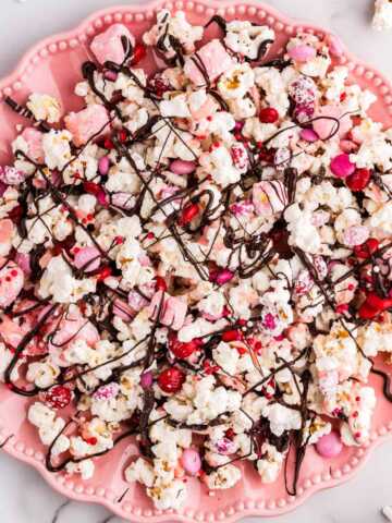 Pink plate with Valentine's Day popcorn.