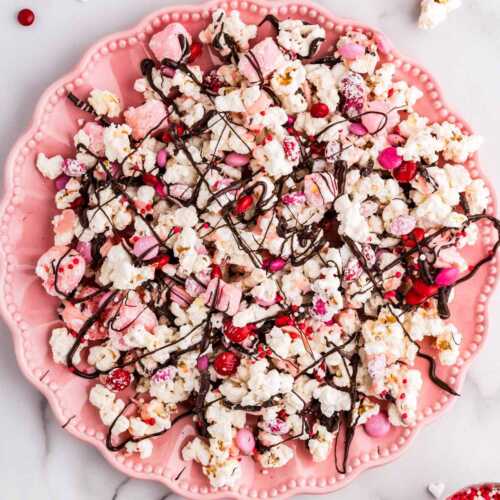 Pink plate with Valentine's Day popcorn.