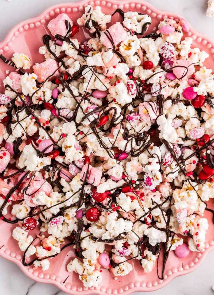 Pink plate with Valentine's Day popcorn.