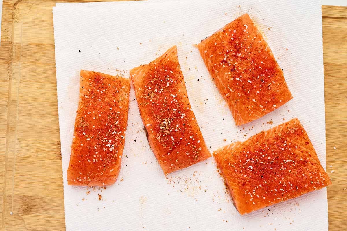 Seasoned salmon on paper towel.