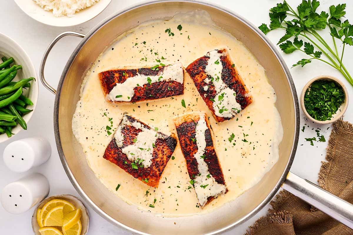 Skillet with creamy dijon sauce and salmon.