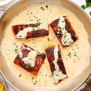 Skillet with creamy dijon sauce and salmon.