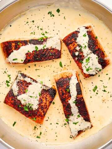 Skillet with creamy dijon sauce and salmon.