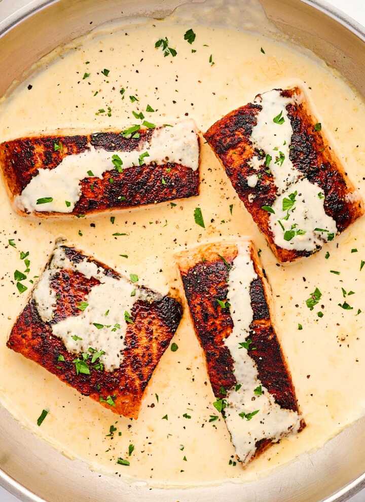 Skillet with creamy dijon sauce and salmon.