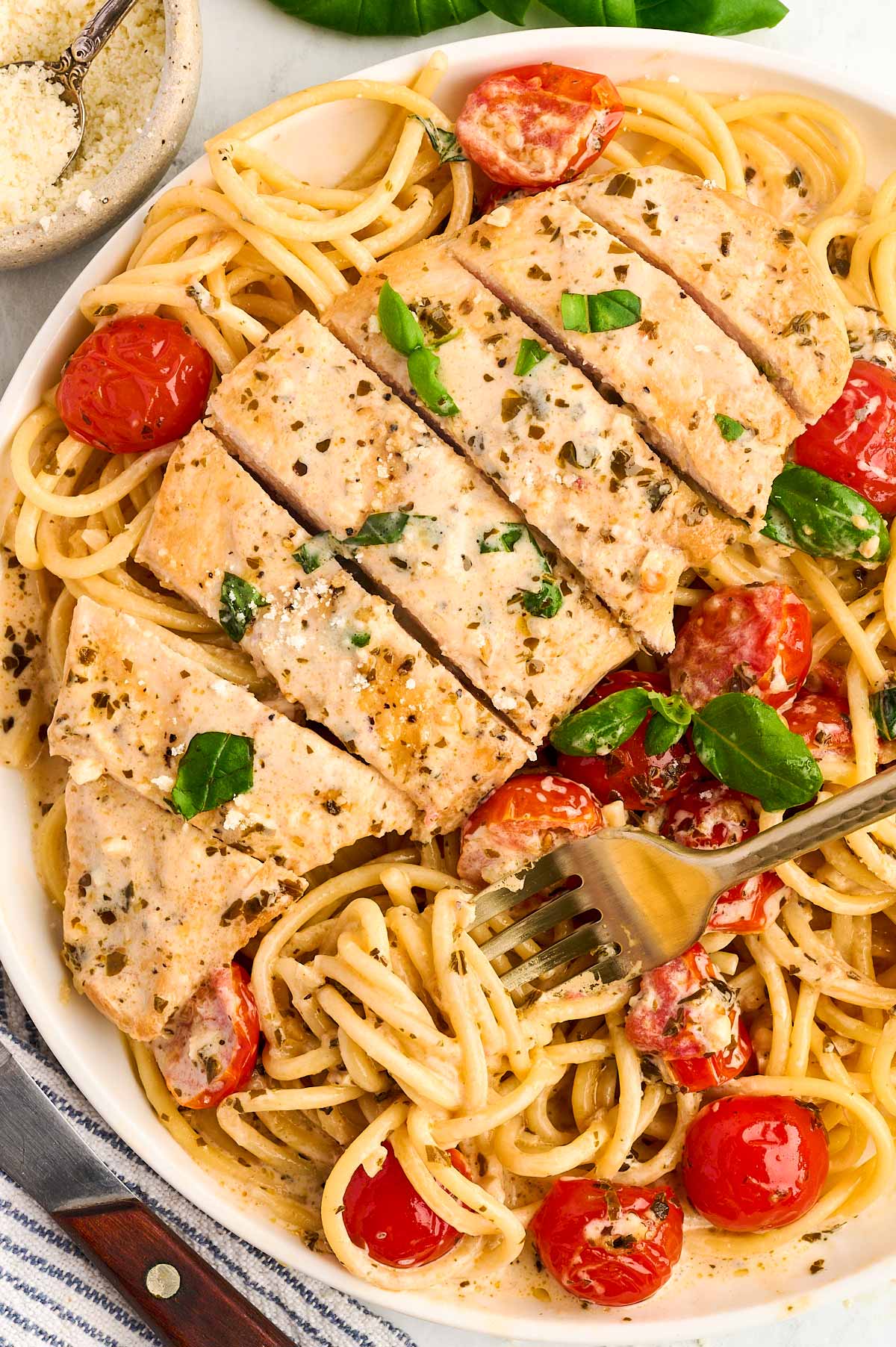 Sliced chicken breast on top of spaghetti.