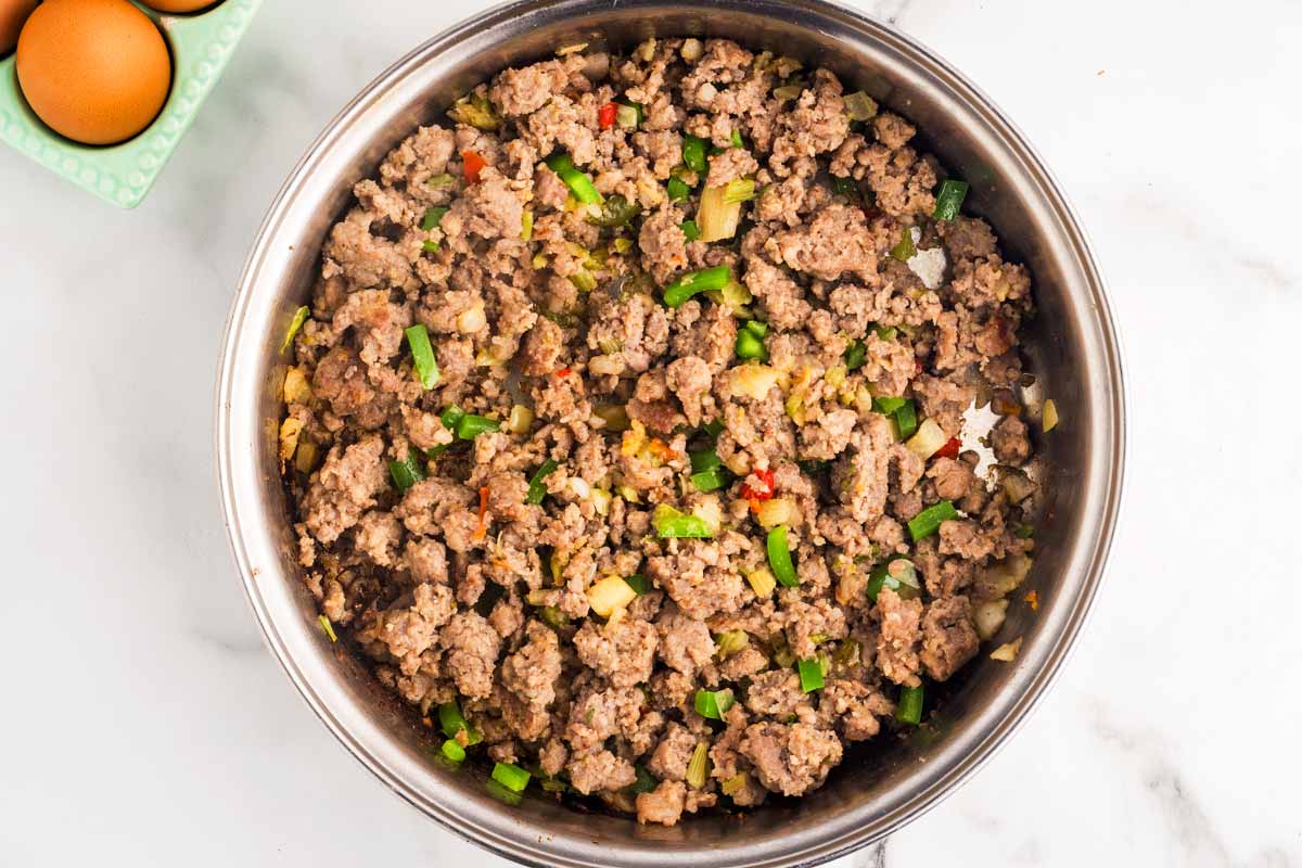 Sautéed sausage and vegetables in skillet.
