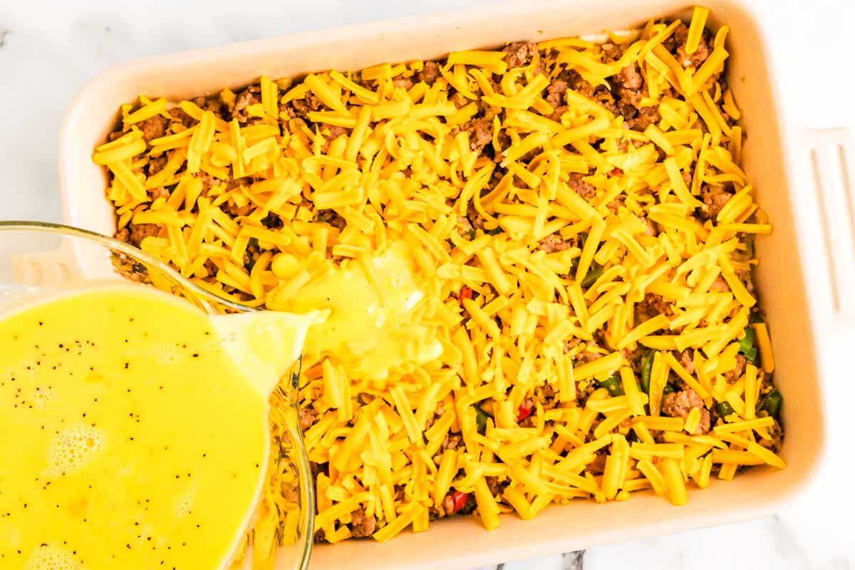 Assembling a breakfast casserole.