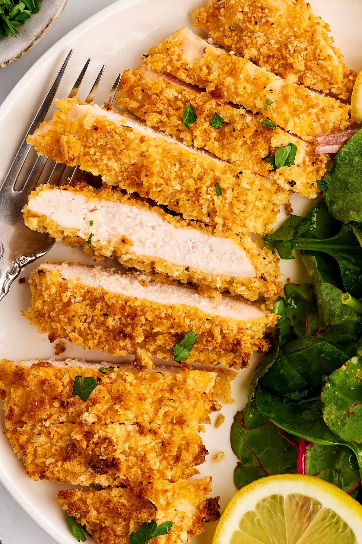 Sliced Chicken cutlet with salad.