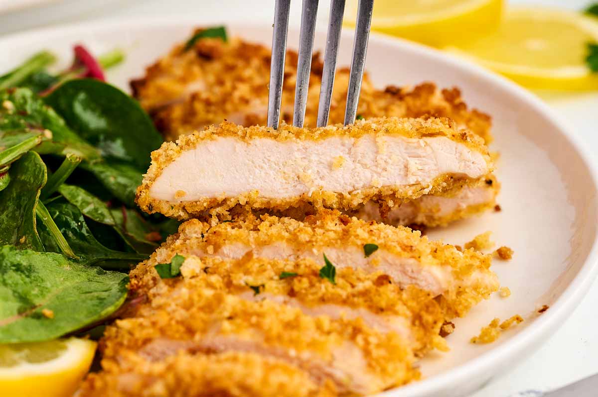 Fork in a sliced chicken cutlet.