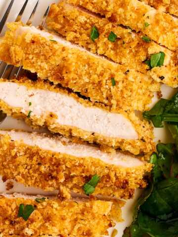 Sliced Chicken cutlet with salad.