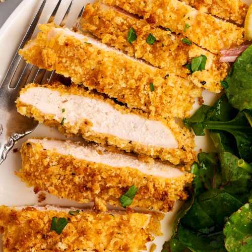 Sliced Chicken cutlet with salad.