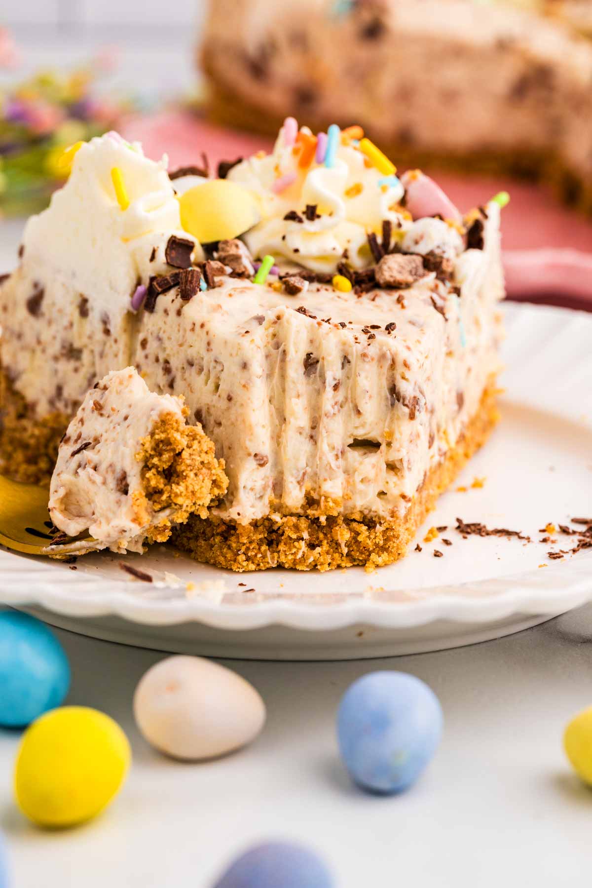 Easter Mini Egg Cheesecake slice with a bite taken out.