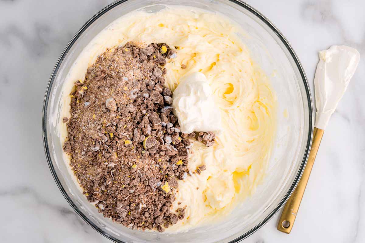 Adding crushed mini eggs to cheesecake filling.