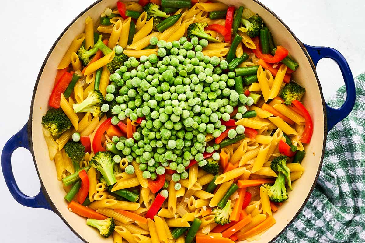 Frozen peas in pan with pasta primavera.