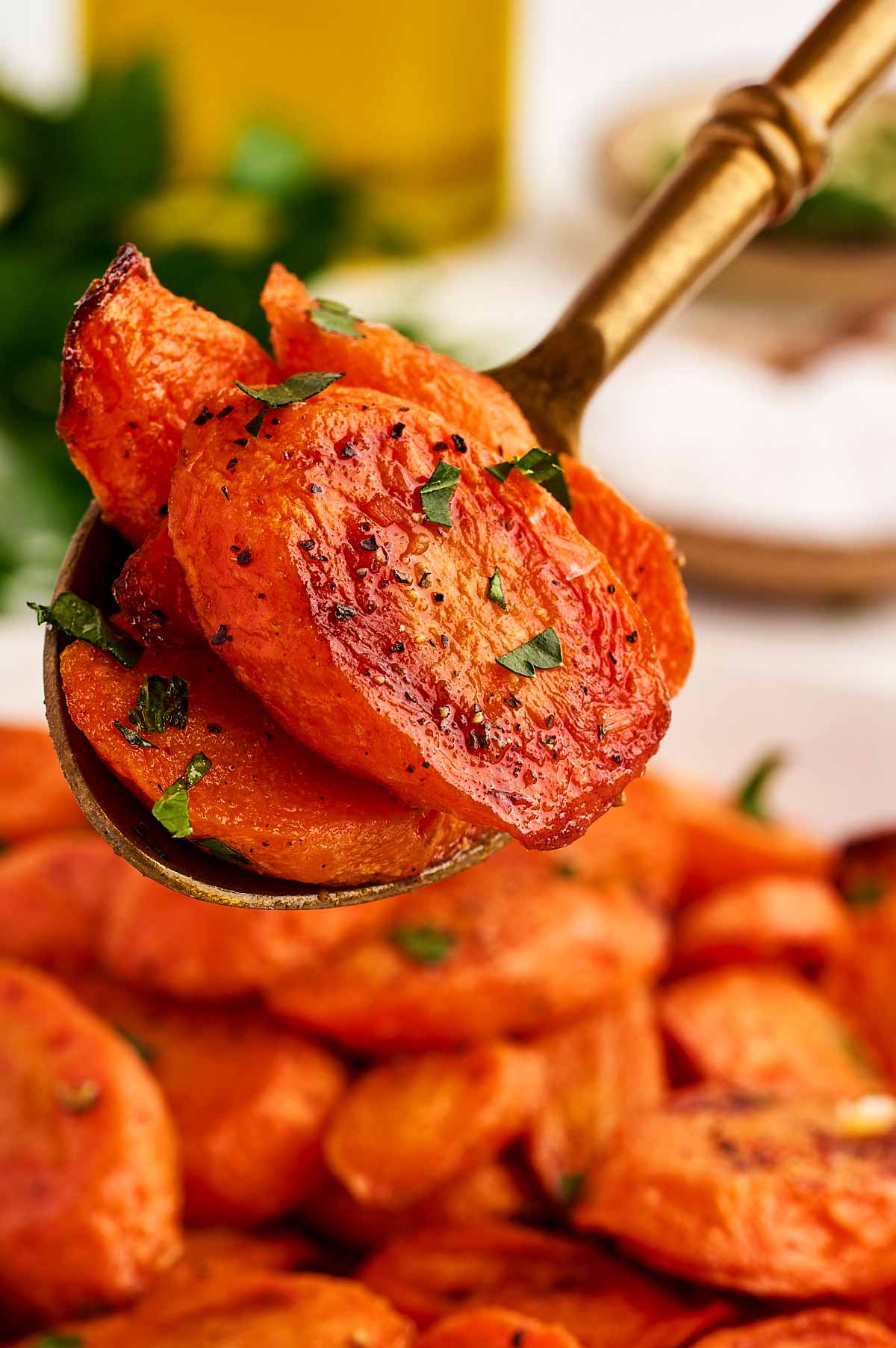 Serving roasted carrots on a spoon.