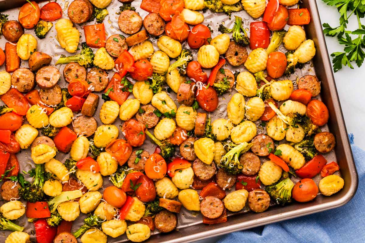 Sheet pan with roasted gnocchi combined with vegetables and sausage.