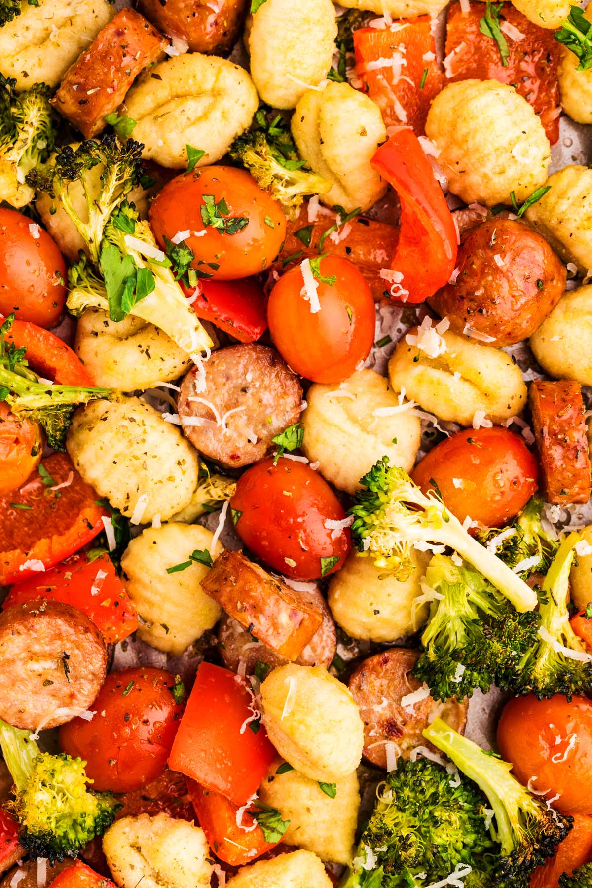 Close up photo of roasted gnocchi with vegetables and sausage.