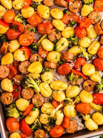 Sheet pan with roasted gnocchi combined with vegetables and sausage.