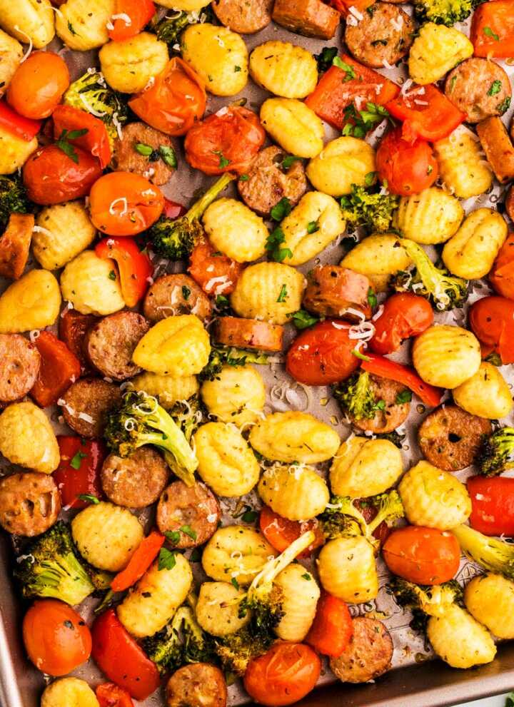 Sheet pan with roasted gnocchi combined with vegetables and sausage.