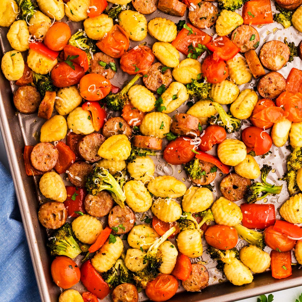 Sheet pan with roasted gnocchi combined with vegetables and sausage.