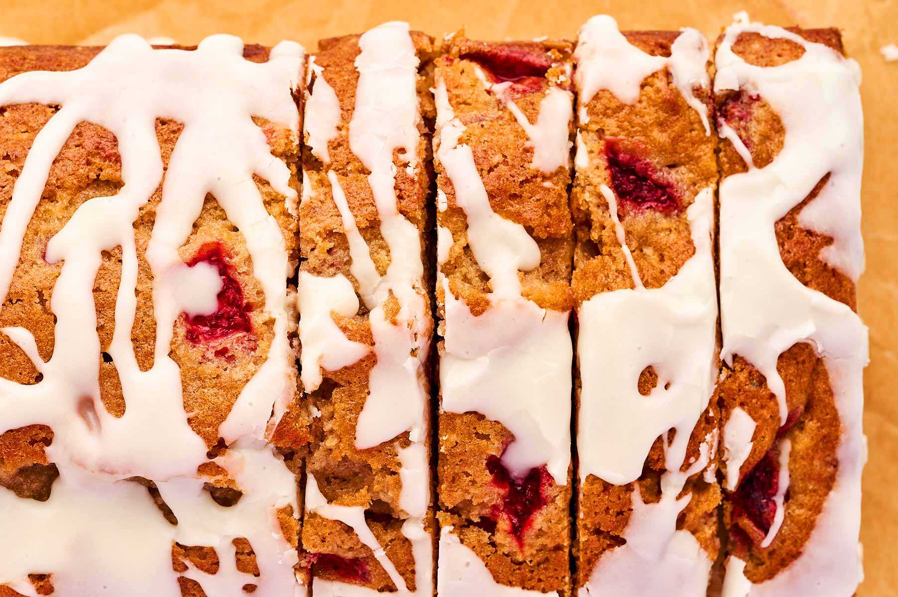 Top down view on sliced strawberry loaf with icing.