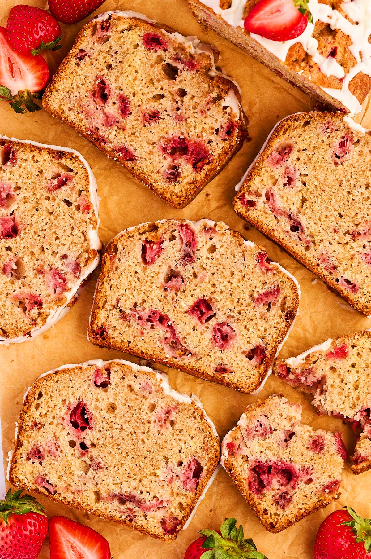 Sliced of strawberry bread on a piece of parchment paper.