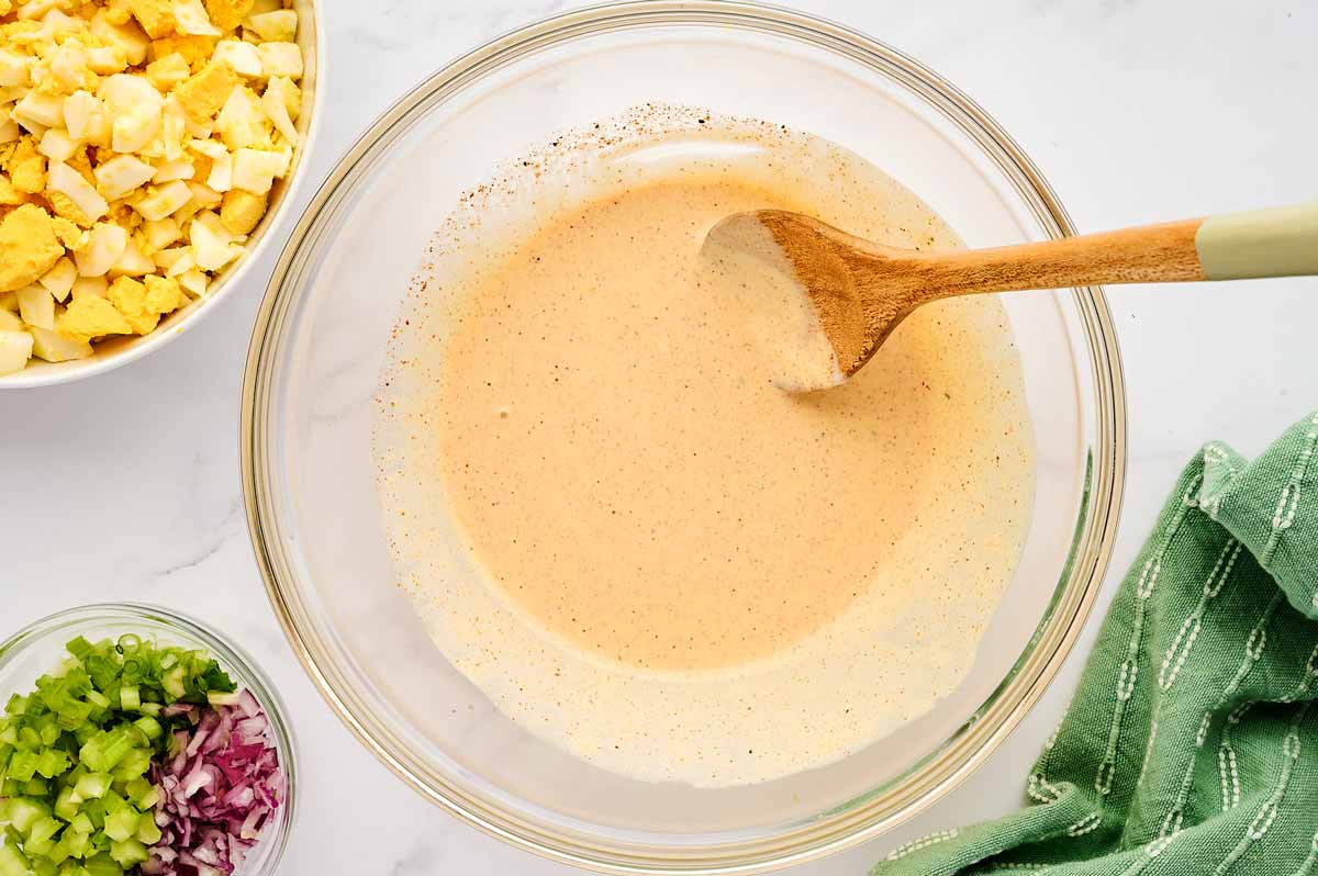 Egg salad dressing in a glass bowl.
