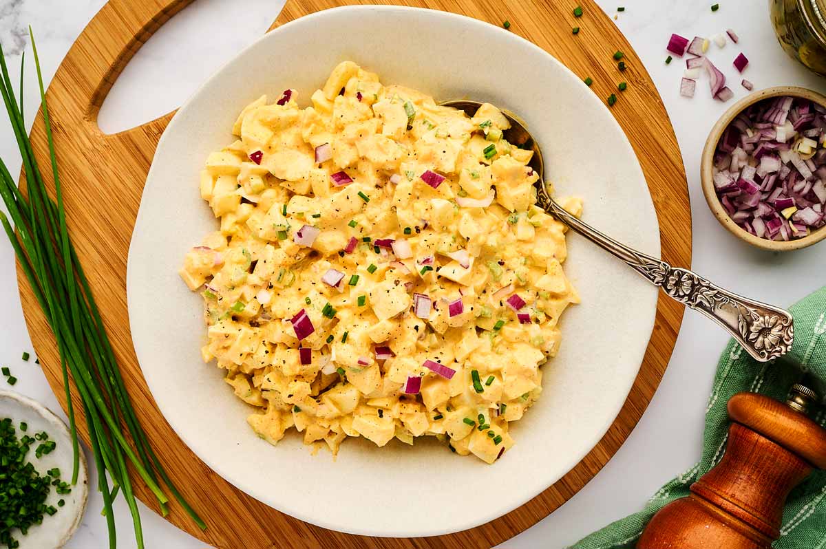 Serving egg salad from a bowl.
