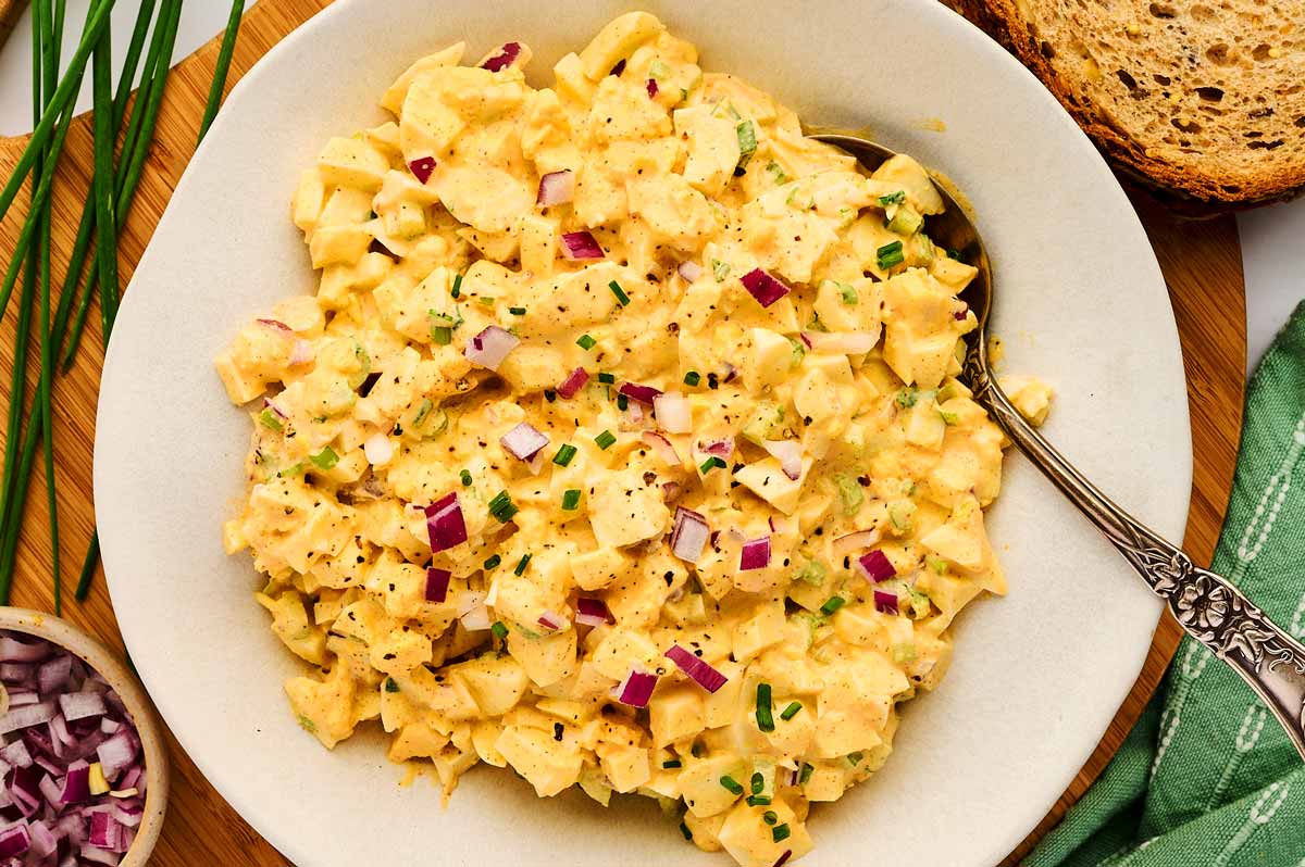 Classic egg salad in a white bowl.