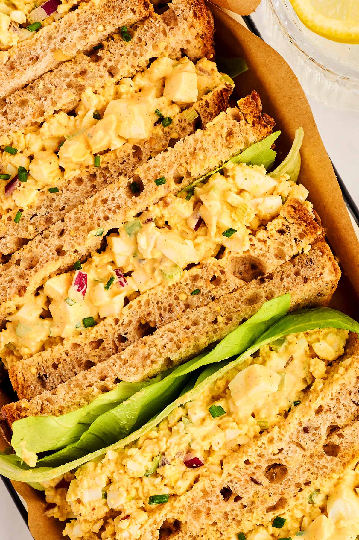 Egg salad sandwiches in a box.