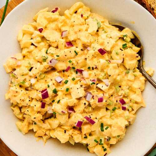 Classic egg salad in a white bowl.