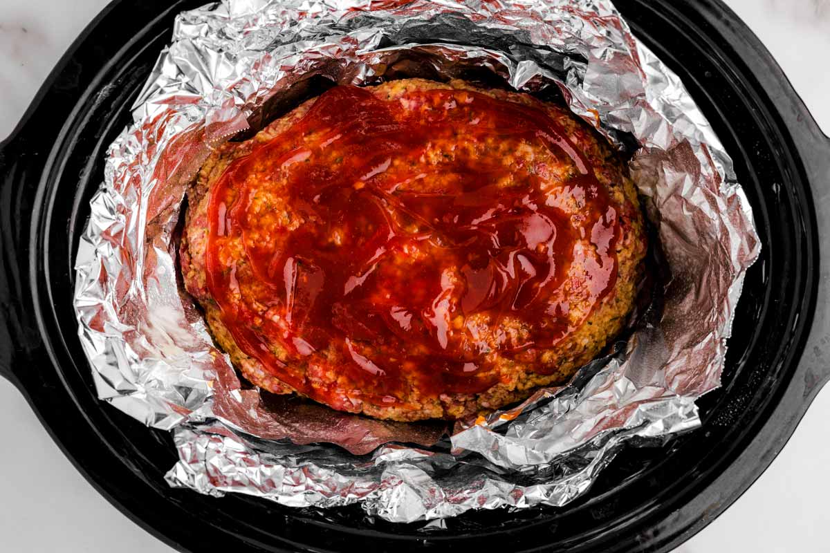 Slow cooked meatloaf in black crock.