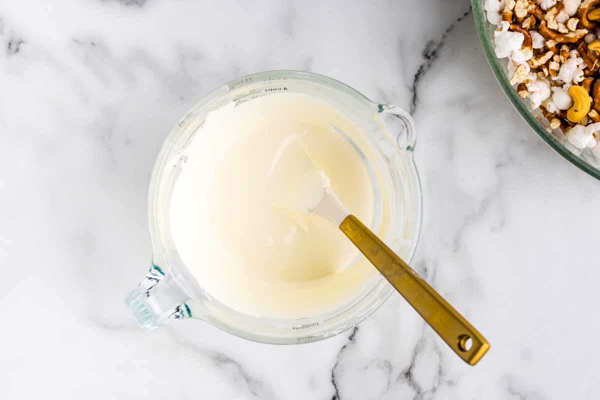 Melted white chocolate in a measuring cup.