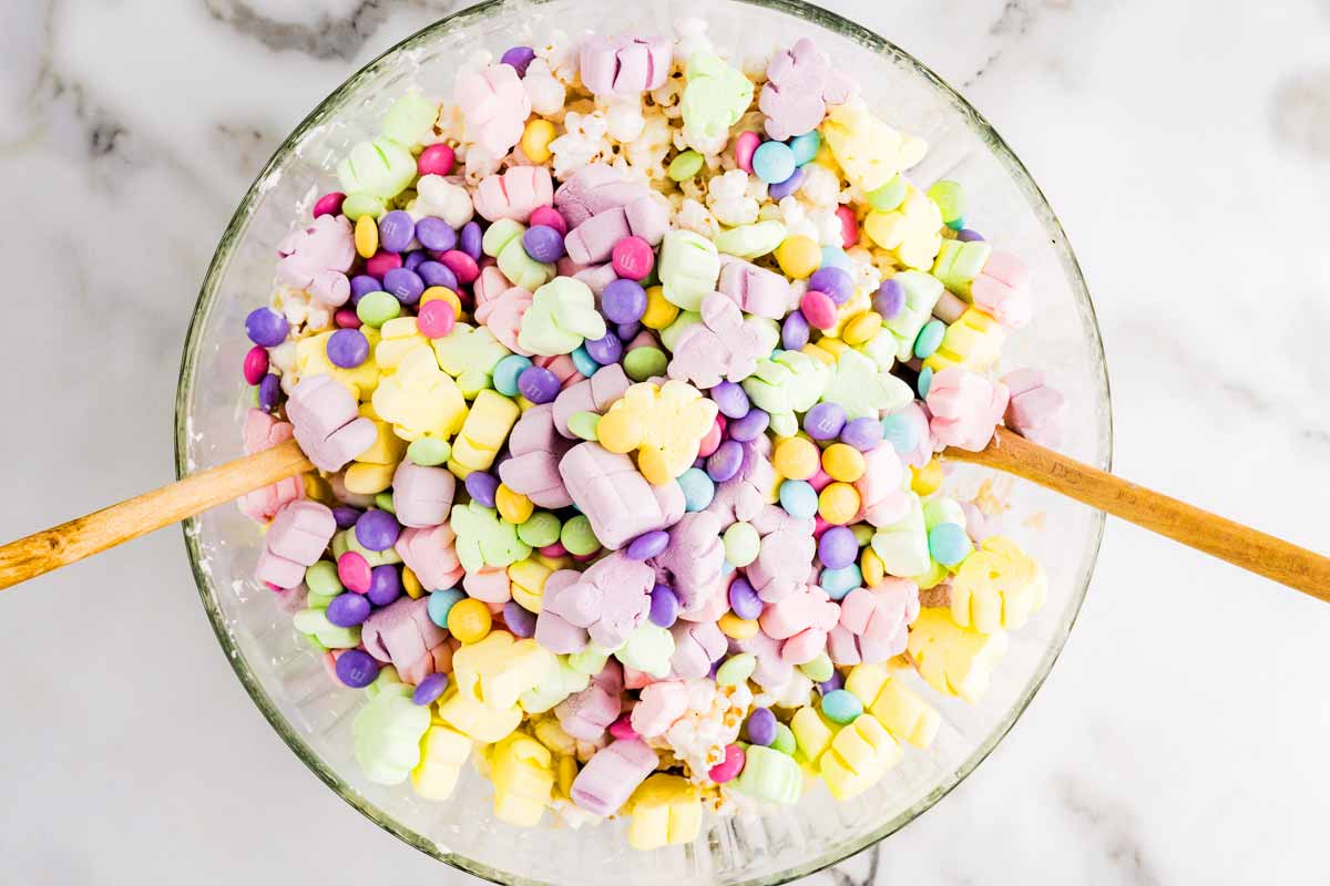 Marshmallows in bowl with popcorn snack mix.