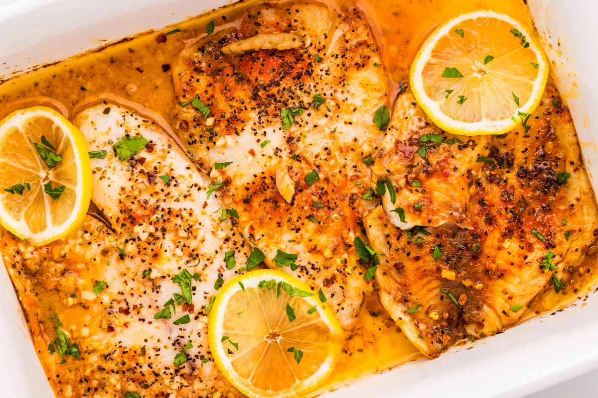 Garlic Butter Baked Tilapia in a white casserole dish.