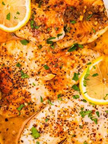Garlic Butter Baked Tilapia in a white casserole dish.