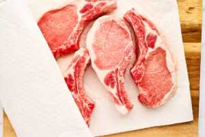 Pork chops patted dry with paper towels.