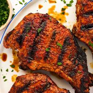 Grilled pork chop on a plate.