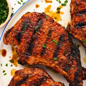 Grilled pork chop on a plate.