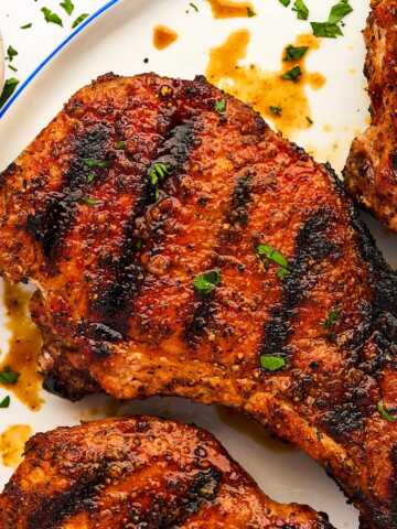 Grilled pork chop on a plate.