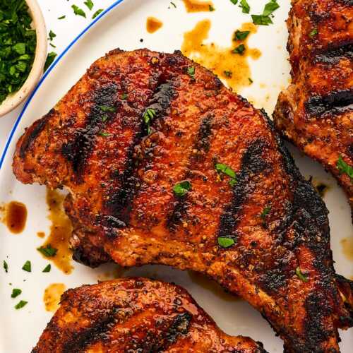 Grilled pork chop on a plate.