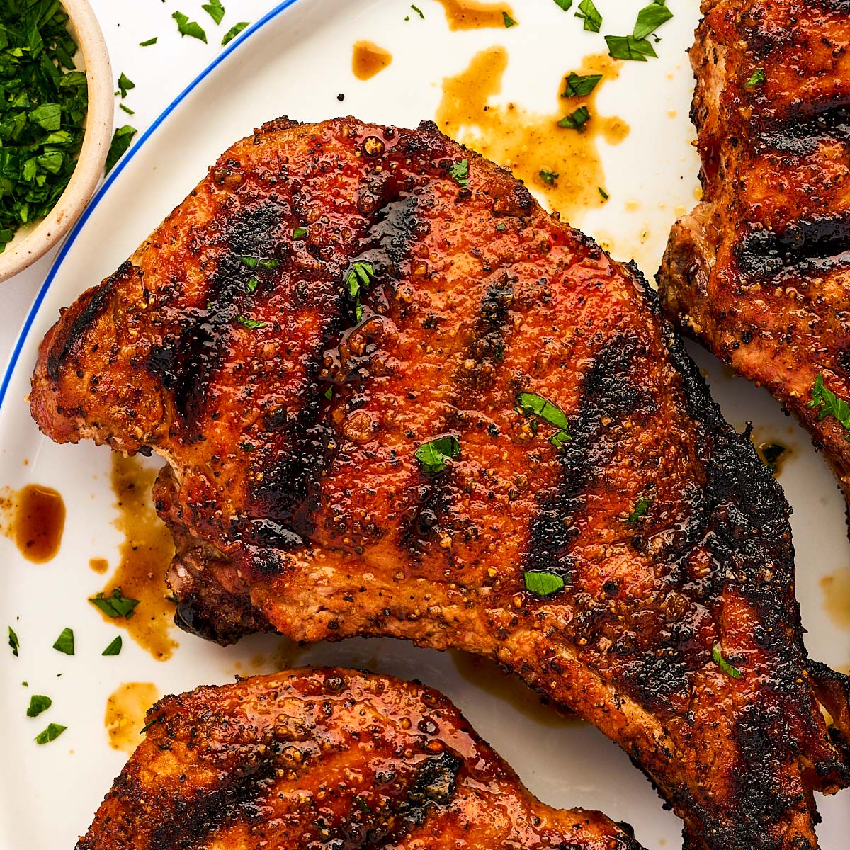 Grilled pork chop on a plate.